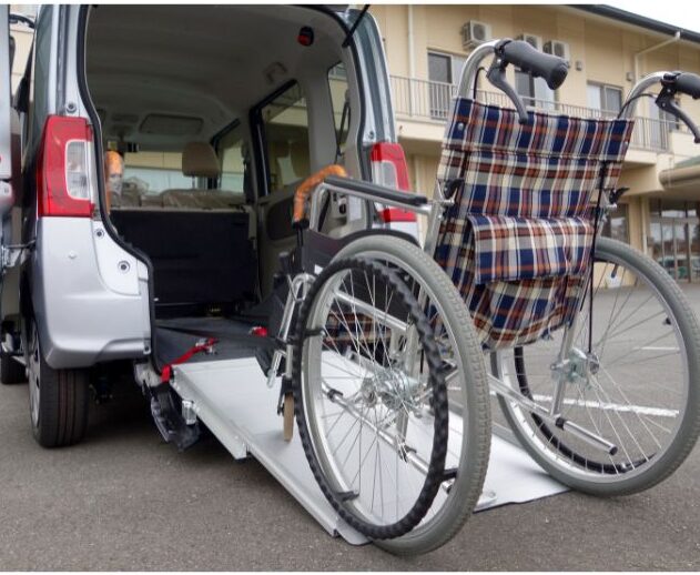 Vacant wheelchair on a ramp, located at the back of a van.
